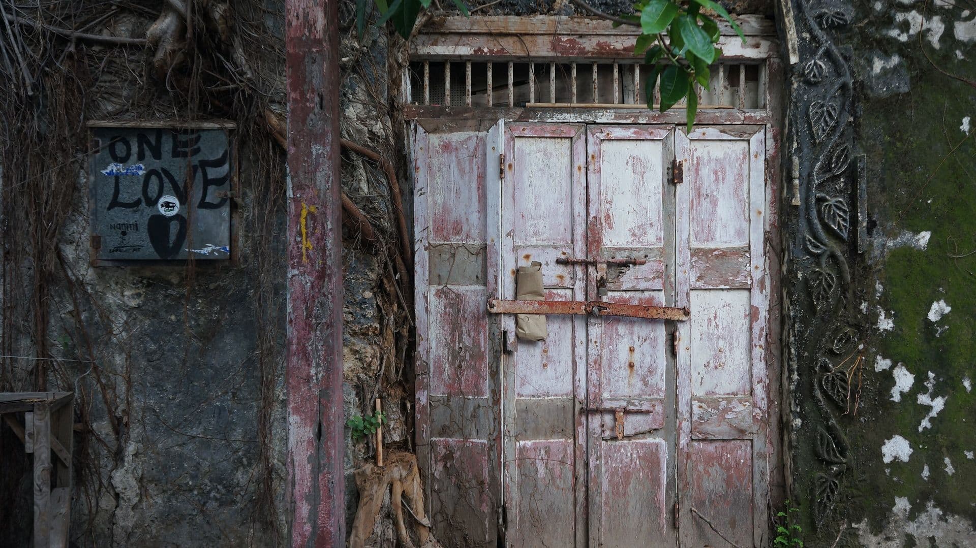 A weathered wooden double door in an old stone wall in Mombasa Old Town